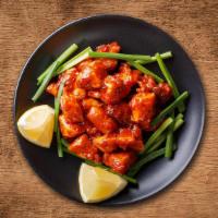 Chicken 65 · Chicken slices marinated with garlic & ginger; then stir-fried and slightly sautéed with gre...