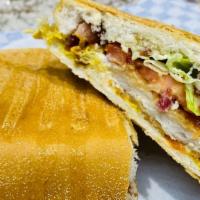 Chicken Sandwich · Chicken steak, lettuce, tomato, mayonnaise, mustard, ketchup, bacon on Cuban bread.