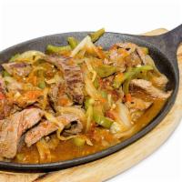 Steak Fajitas · Strips of carne asada sauteed with tomatoes, green bell peppers and onions. Served with 2 si...