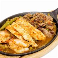 Mixed Fajitas · Strips of carne asada, chicken and shrimps  sauteed with tomatoes, green bell peppers and on...