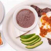 Tipico Guanaco (New York Strip Steak) · Grilled NY Steak topped with 2 fried eggs with tomato sauce, cheese, avocado, beans, and hou...
