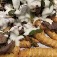 Beef Cheesesteak Fries · Beef cheesesteak loaded on top of fries with peppers, onions, american cheese, provolone, an...