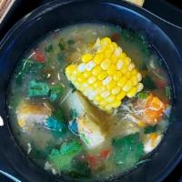 Sancocho De Gallina · 12-hour slow-cooked hen soup, served with 2 arepitas