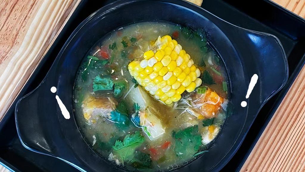Sancocho De Gallina · 12-hour slow-cooked hen soup, served with 2 arepitas