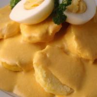 Papa A La Huancaina · Boiled potatoes covered in a Peruvian yellow creamy sauce.