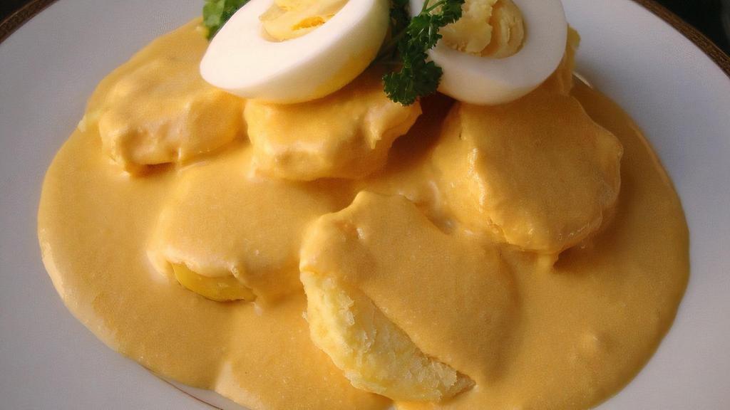 Papa A La Huancaina · Boiled potatoes covered in a Peruvian yellow creamy sauce.