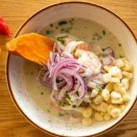 Ceviche · Fish and seafood marinated in lime juice with a touch of garlic, chopped cilantro, onions in...