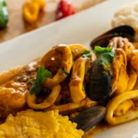 Pescado A Lo Macho · Grilled fish fillet covered with seafood in a Peruvian roasted yellow chili pepper sauce(NON...