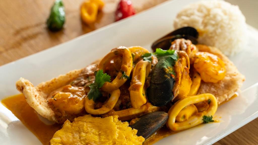Pescado A Lo Macho · Grilled fish fillet covered with seafood in a Peruvian roasted yellow chili pepper sauce(NON SPICY), served with jasmine rice and fried yuca.
