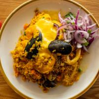 Arroz Con Mariscos · Peruvian paella style, seafood and jasmine rice slowly cooked in a Peruvian yellow pepper mo...