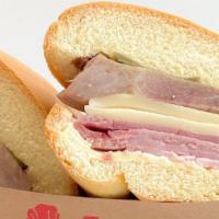 Medianoche · Midnight sandwich on sweet bread with ham, pork, and Swiss cheese.