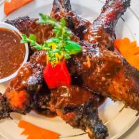 Jerk Wings · Served with Rice and Peas and Cabbage