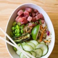 Tuna Poke Bowl · Sushi grade tuna, rice, edamame, cucumber, Asian slaw, and soy sesame vinaigrette topped wit...