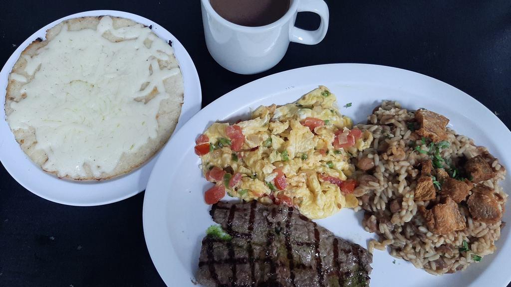 Calentado Con Huevo Y Carne · Colombian breakfast mix of white rice, red beans and cut pork belly (chicharrón). Servido con arepa, queso molido y chocolate o café / served with arepa, withe ground cheese and hot chocolate or coffee.