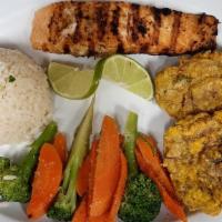 Salmon A La Plancha. · Grilled salmon.Served with rice, vegetables and tostones.