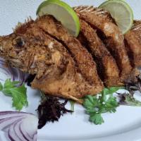 Mojarra Frita · “Colombian fish”. Deep-fried fish. Served with white rice,salad and tostones.
