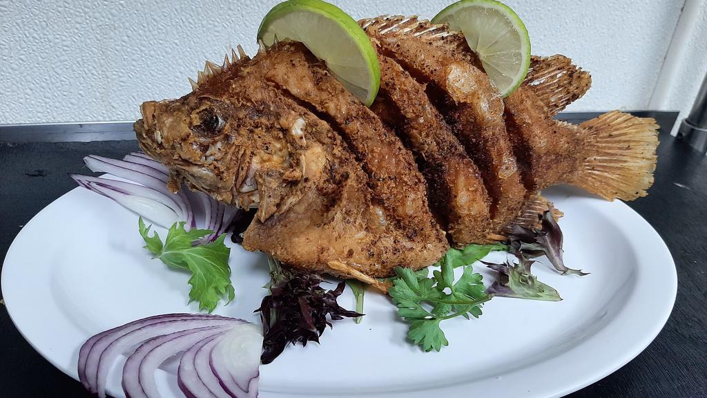 Mojarra Frita · “Colombian fish”. Deep-fried fish. Served with white rice,salad and tostones.