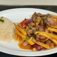 Lomo Salteado · Tender beef. Marinated with soy sauce and spices, stir fried with onions and tomatoes. Serve...