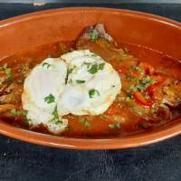 Bistec A Caballo · Grilled thin top round steak, topped with Special homemade sauce served with two fried eggs ...