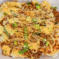 Chili & Cheese Potato · Our famous chili served over a giant baked potato. Topped with shredded Cheddar cheese, gree...
