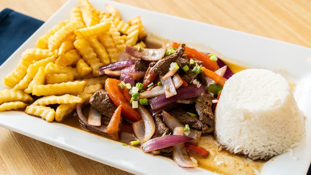 Lomo Saltado · Sauteed beef tenderloin, onions, tomato served with rice french fries.