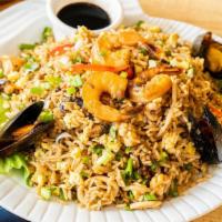 Chaufa De Mariscos · Rice, seafood, soy sauce, ginger, egg, green onions, peppers and sesame oil.