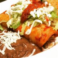 Enchiladas · Two corn tortillas dipped in a homemade chile salsa, pan seared with your choice of meat and...