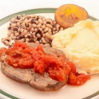 Meatloaf W/ Creole Sauce · Meatloaf with creole sauce on side, blue plate served w/ 2 sides and a corn muffin.