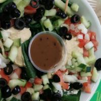 Greek Salad · Hummus, Feta cheese, black olives, onion, tomato, cucumber, spinach, and balsamic vinaigrette.