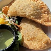 Empanada De Carne · Two empanadas with ground beef, green olives and spices.