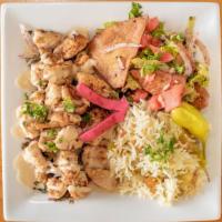 Chicken Shawarma Plate · sliced marinated chicken breast on top of parsley and onions topped with our homemade tahini...