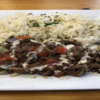 Lamb Shawarma Plate · sliced marinated lamb leg on parsley and onions topped with our homemade tahini sauce