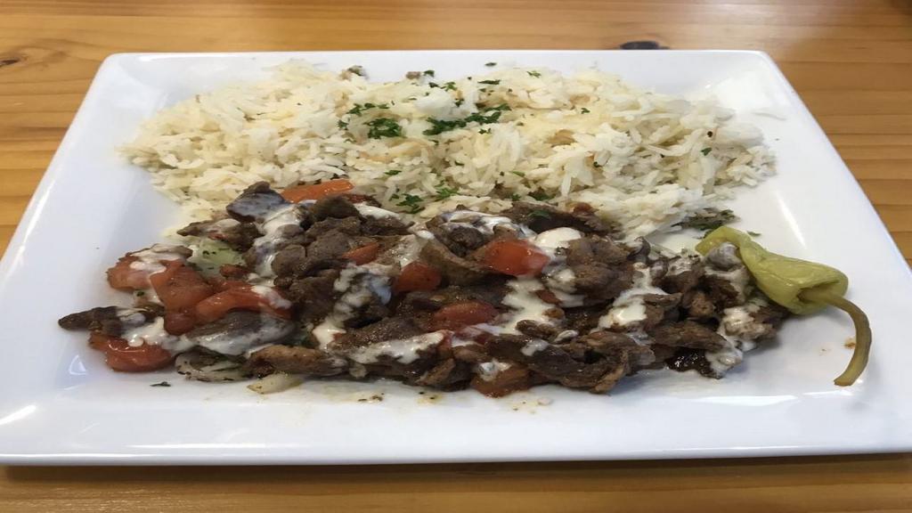 Lamb Shawarma Plate · sliced marinated lamb leg on parsley and onions topped with our homemade tahini sauce