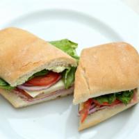Ham & Turkey Pesto Sandwich · Ham, roasted turkey, Provolone cheese, lettuce, tomato, red onion and pesto aioli on multigr...