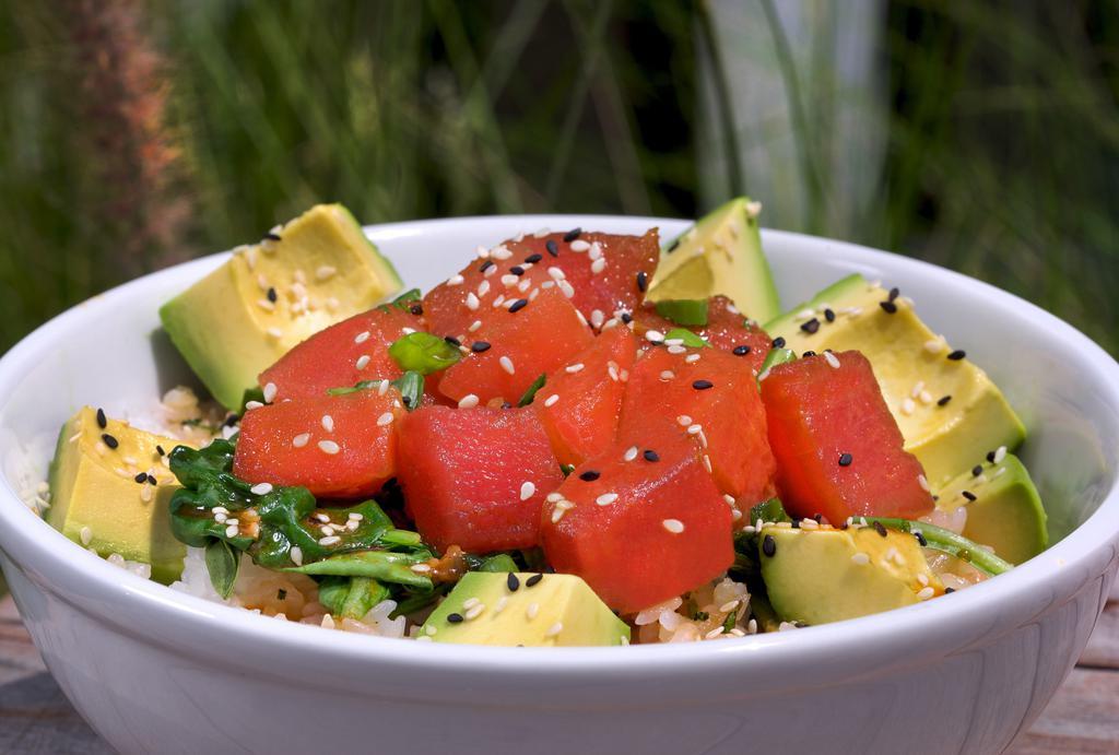 Caliche'S Poke Bowl · Straight from wishbones in playa Jaco-fresh sushi-grade ahi tuna seasoned with caliche's secret marinade. Served with steamed spinach over sticky rice. Finished with diced avocados, green onions, and sesame seeds. Pura Vida!