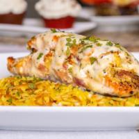 Seafood Stuffed Salmon · Fresh Salmon stuffed with shrimp, lump crabmeat, Tuscan cheese and smoked. Served over a bed...