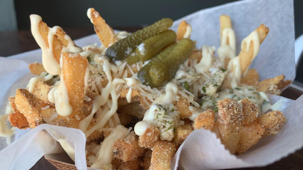 Garlic Parmesan Fries · Fries tossed with Grated Parmesan, Garlicy Seasoning, then Topped with Shredded Parmesan, a Dollop of Maitre 'D Butter, Dijon Aioli Drizzle  & Cornichons
