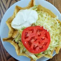 Chicken Taco Salad · Served on a bed of rice topped with lettuce, tomatoes sour cream and cheese.
