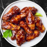 Blazing Bbq Wings · Fresh chicken wings fried until golden brown and tossed in barbecue sauce. Served with a sid...