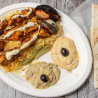 Chicken Tikka Platter · Rice, pickles, tomatoes, onions, garlic sauce, pita bread, hummus, and baba ghanoush.