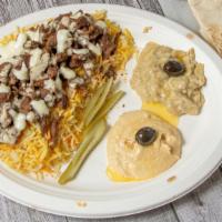 Beef Shawarma Platter · Rice, pickles, tomatoes, onions, tahini sauce, pita bread, hummus, and baba ghanoush.