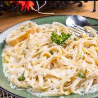 Classic Fettuccine Alfredo · Our famous home-made creamy alfredo sauce tossed in with fresh fettuccine pasta. Served with...