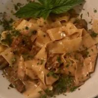 Pappardelle “Tartufate” · Homemade over sized pasta served with porcini mushrooms, onions in a creamy white truffle oil.