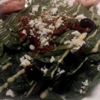 Insalata Luna · Fresh spinach salad served with goat cheese, black olives, pine-nuts, sun-dried tomatoes tos...