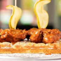 Nashville Chicken & Waffles · fried chicken tossed in our nashville hot sauce over belgian waffles.