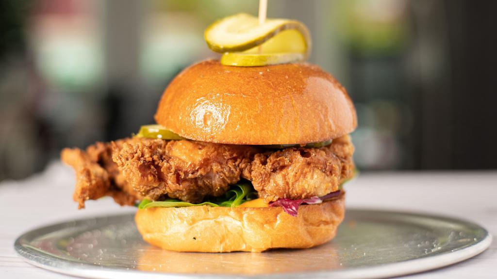 Og Chicken Sandwich · fried chicken served on a brioche bun, with greens, tomato, pickles and bang sauce.