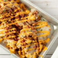 Dirty Fries · zesty waffle fries garnished with sausage gravy, bacon and bang sauce.