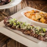 Churrasco · Juicy grilled skirt steak with chimichurri mojito sauce served with gratin potatoes and hous...