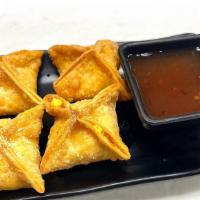 Crab Rangoon · Crispy fried blue crab meat and curried cream cheese wontons served with plum vinaigrette di...