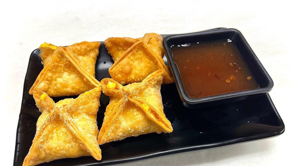 Crab Rangoon · Crispy fried blue crab meat and curried cream cheese wontons served with plum vinaigrette dipping sauce.